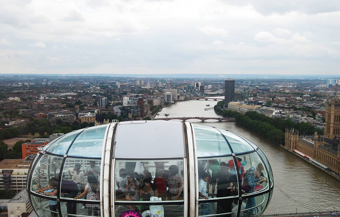 London, England, UK - July 27, 2010: Tourists inside the "London Eye" on a cloudy overcast day.