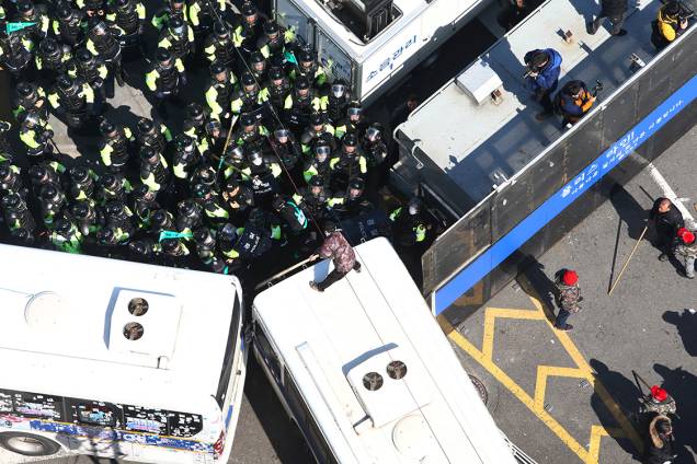 Manifestante desafia polícia subindo em cima de uma van, durante protesto na Coreia do Sul, em apoio a presidente afastada, Park Geun-hye Manifestante desafia polícia subindo em cima de uma van, durante protesto na Coreia do Sul, em apoio a presidente afastada, Park Geun-hye