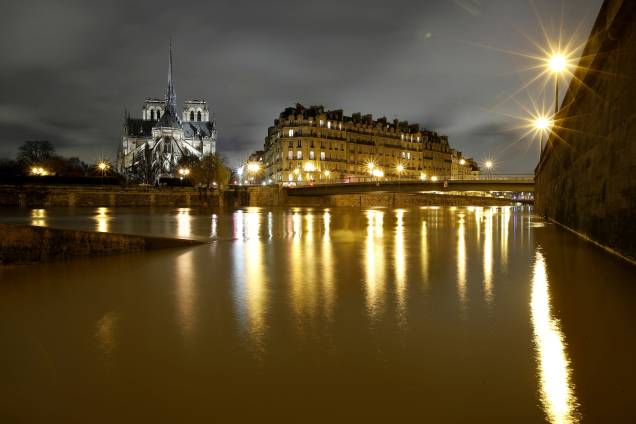 A Catedral de Notre Dame é vista à noite, às margens do rio Sena, em Paris, após dias de chuvas incessantes que causaram inundações na França - 25/01/2018 A Catedral de Notre Dame é vista à noite, às margens do rio Sena, em Paris, após dias de chuvas incessantes que causaram inundações na França - 25/01/2018