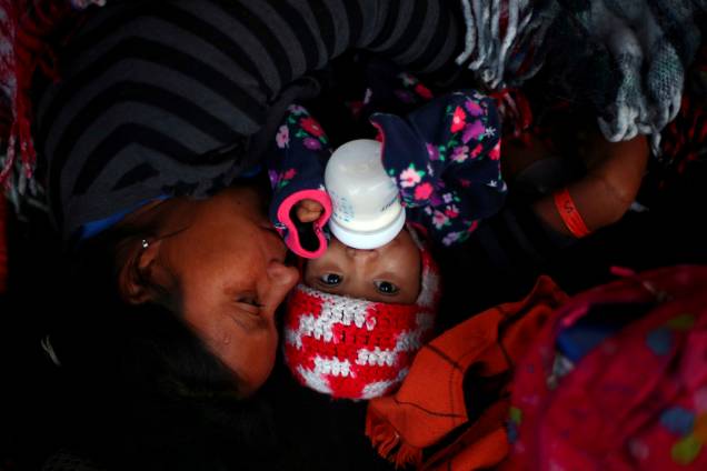 Mãe e bebê descansam enquanto aguardam para atravessar a fronteira entre o México e os Estados Unidos, na cidade de Tijuana - 23/11/2018 Mãe e bebê descansam enquanto aguardam para atravessar a fronteira entre o México e os Estados Unidos, na cidade de Tijuana - 23/11/2018