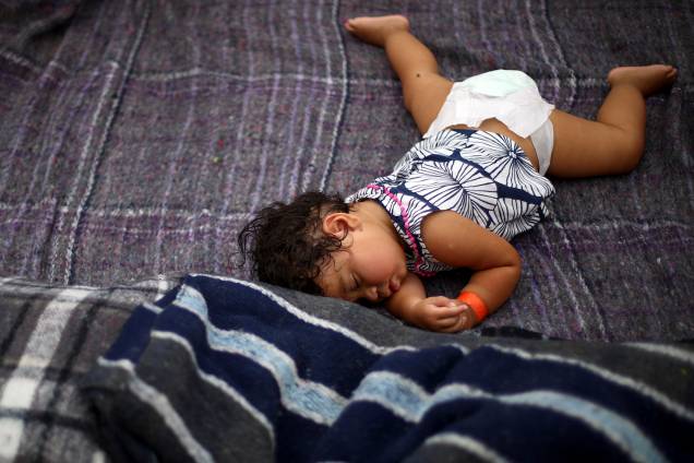 Garota descansa em acampamento improvisado montado por membros da caravana de imigrantes da América Central, nos arredores da fronteira entre o México e os Estados Unidos, na cidade de Tijuana - 24/11/2018 Garota descansa em acampamento improvisado montado por membros da caravana de imigrantes da América Central, nos arredores da fronteira entre o México e os Estados Unidos, na cidade de Tijuana - 24/11/2018