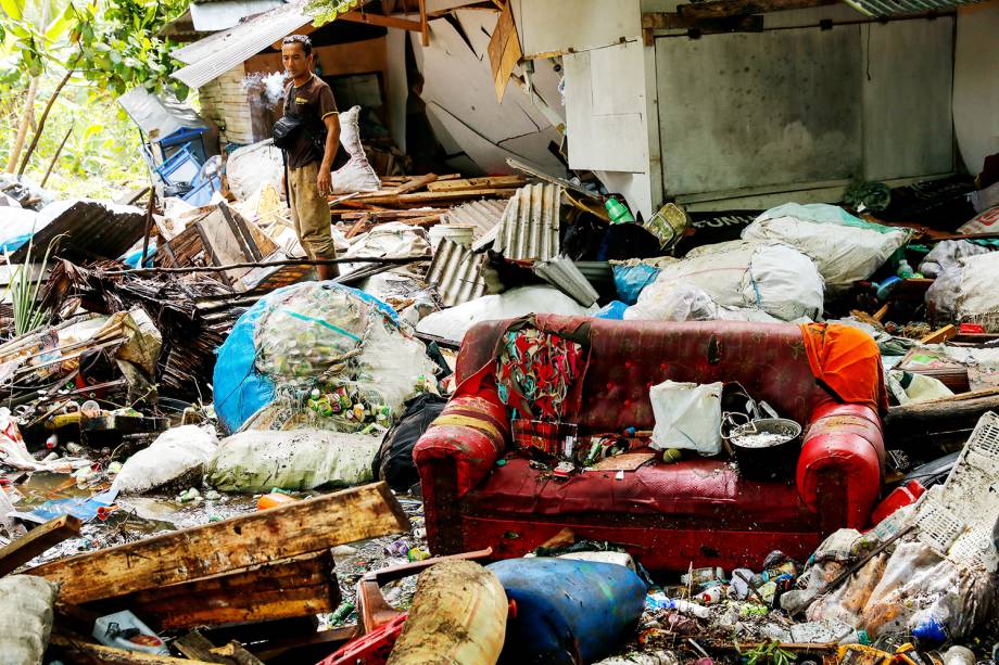 Homem observa destroços após forte tsunami atingir a regência de Pandeglang, localizada na província de Banten, na Indonésia - 24/12/2018