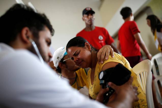 Mulher recebe atendimento médico depois que uma barragem de propriedade da mineradora Vale rompeu em Brumadinho (MG) - 26/01/2019 Mulher recebe atendimento médico depois que uma barragem de propriedade da mineradora Vale rompeu em Brumadinho (MG) - 26/01/2019