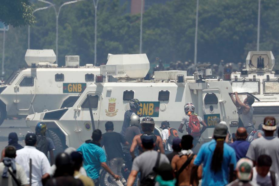 Manifestantes de oposição entram em confronto com forças leais a Nicolás Maduro perto da base aérea La Carlota em Caracas, na Venezuela - 30/04/2019