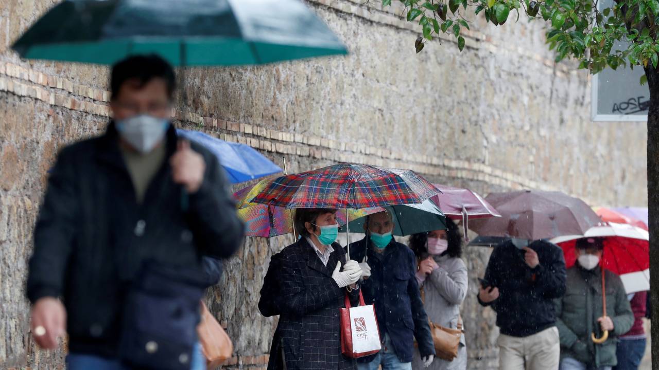 FILE PHOTO: People queue to receive free protective masks that have been bought by evangelicals in China and are distributed by Members of the Evangelical Christian Church, as the spread of the coronavirus disease (COVID-19) continues, in Rome, - 22/04/2020