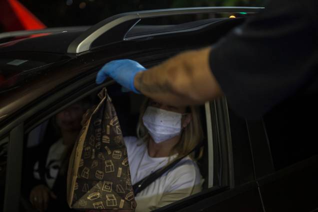 Primeiro, passam por um stand e sem sair do carro recebem o seu "kit alimentação" Primeiro, passam por um stand e sem sair do carro recebem o seu "kit alimentação"