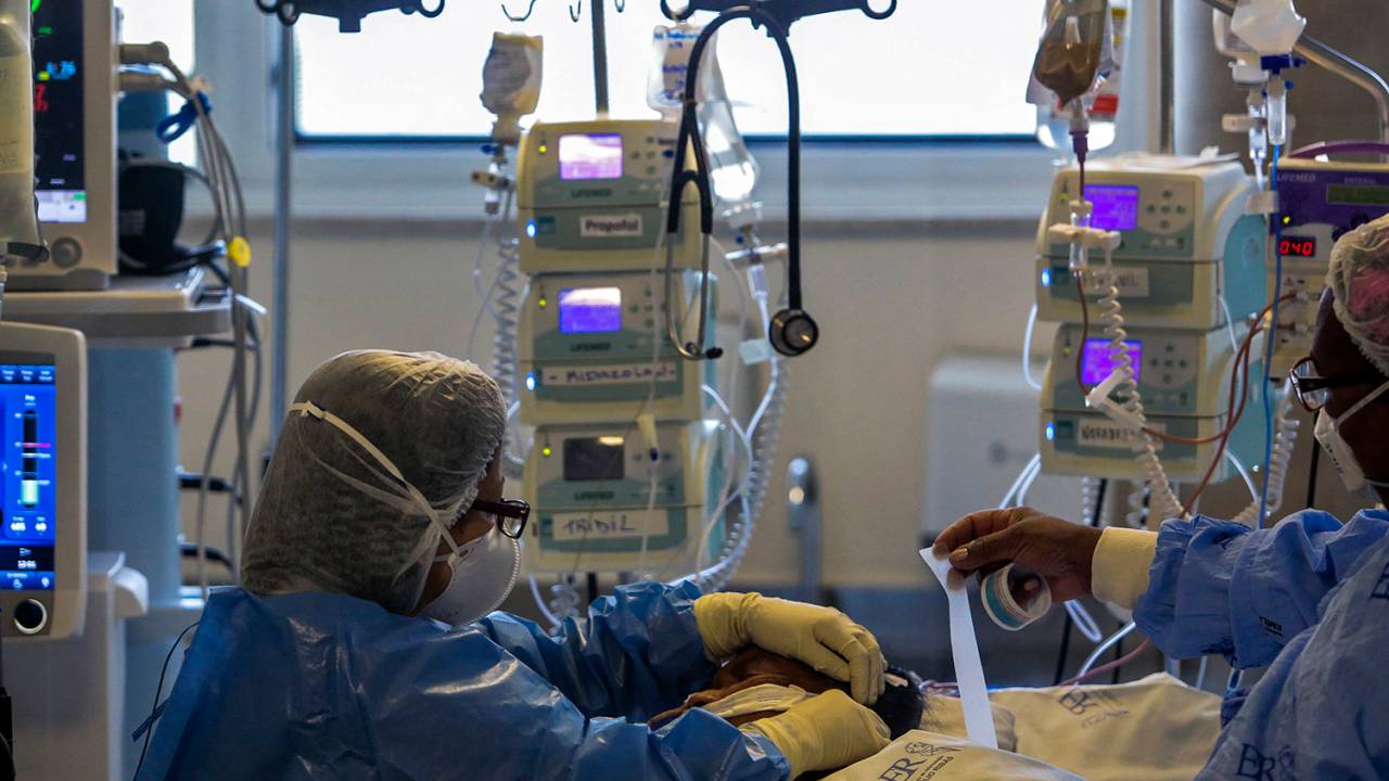 Health workers care for a COVID-19 patient who remains in the Intensive Care Unit of the Emilio Ribas Hospital in Sao Paulo, Brazil, on March 17, 2021. Sao Paulo reached an occupancy of 90% of ICU beds for the first time since the pandemic started.