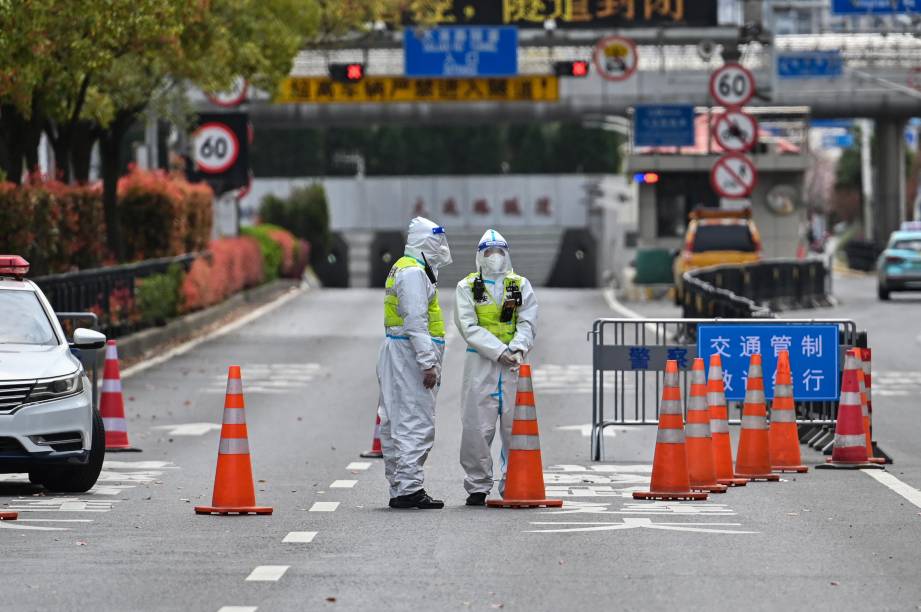 Policiais chineses, fiscalizam acessos, em virtude do regime de Lockdown, em Pudong distrito de Xangai devido ao aumento significativo de casos de Covid-19.