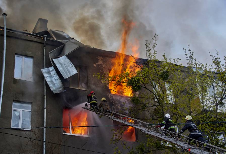 Bombeiros trabalhando logo após um bombardeio russo em Kharkiv, Ucrânia, 17 de abril de 2022. -