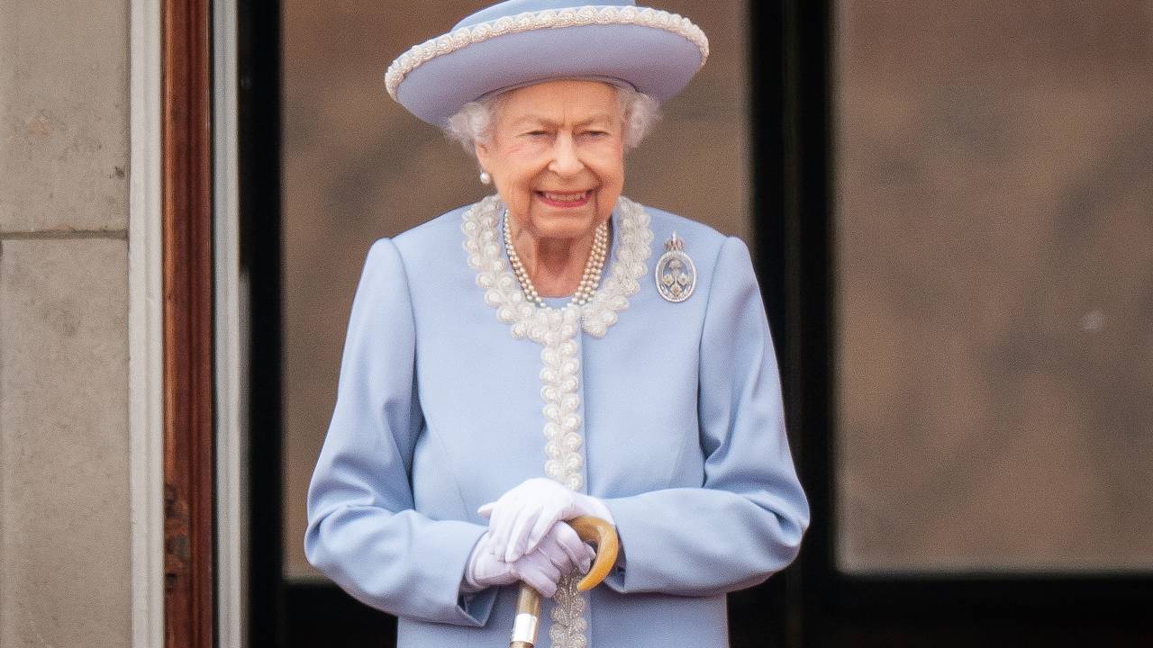 LONDON, ENGLAND - JUNE 02: Queen Elizabeth II watches from the balcony at Buckingham Palace for the Trooping the Colour ceremony parade on June 2, 2022 in London, England. Trooping The Colour, also known as The Queen's Birthday Parade, is a military ceremony performed by regiments of the British Army that has taken place since the mid-17th century. It marks the official birthday of the British Sovereign. This year, from June 2 to June 5, 2022, there is the added celebration of the Platinum Jubilee of Elizabeth II in the UK and Commonwealth to mark the 70th anniversary of her accession to the throne on 6 February 1952. (Photo by Aaron Chown - WPA Pool/Getty Images)