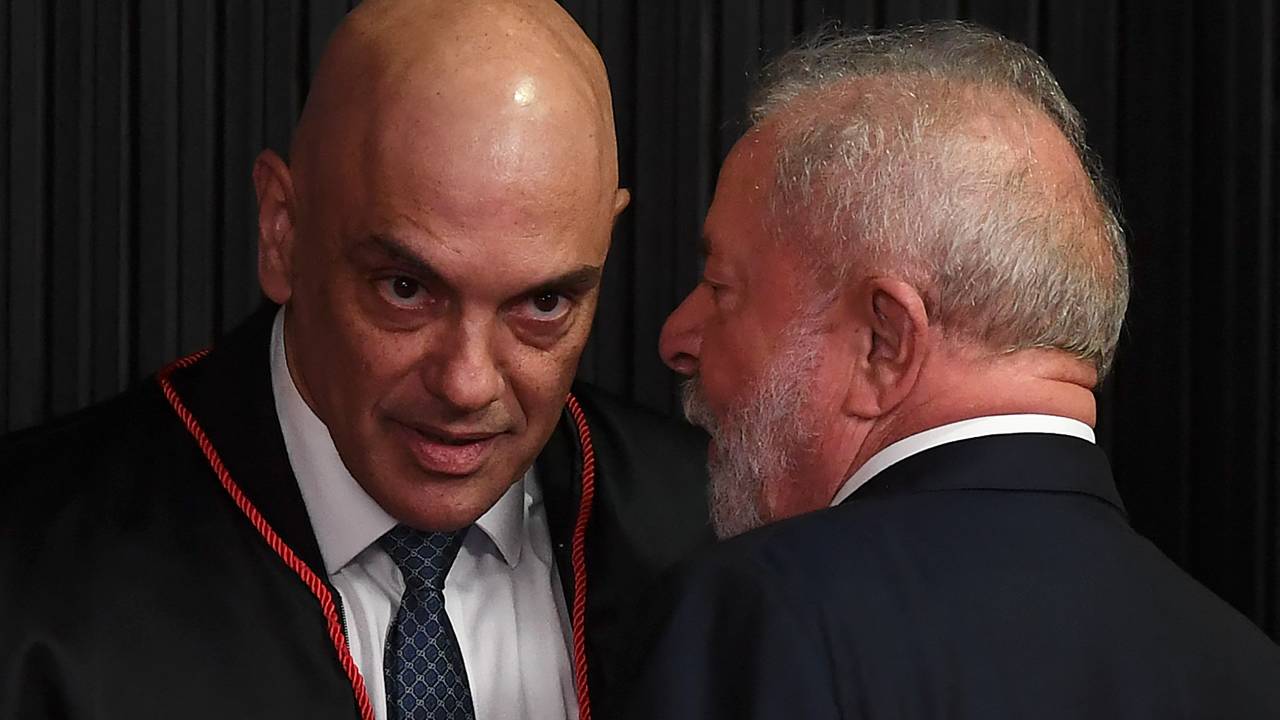 Brazilian presidential candidate for the leftist Workers Party (PT) and former President (2003-2010), Luiz Inacio Lula da Silva (R) greets Brazilian judge Alexandre de Moraes after he took over as head of the Superior Electoral Tribunal, at the TSE headquarters in Brasilia, on August 16, 2022. - The TSE is the institution responsible for refereeing the South American giant's October elections and punishing violations of electoral law. Openly reviled by President Jair Bolsonaro, de Moraes may have to show the stuff that earned him the nickname "RoboCop" as arbiter in polarizing, disinformation-plagued elections to decide the far-right incumbent's fate. (Photo by EVARISTO SA / AFP)