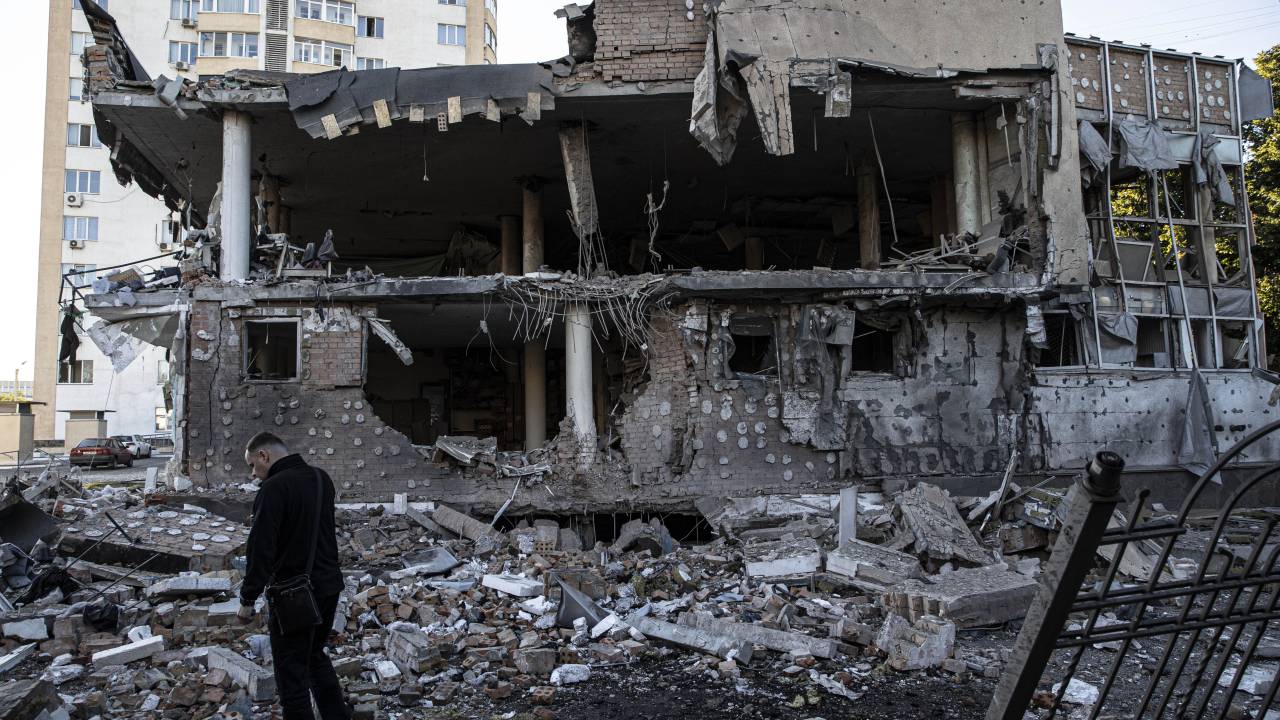 KHARKIV, UKRAINE - SEPTEMBER 07: A man is seen standing in front the rubble of a building hit by Russian missile strike in the Ukrainian city of Kharkiv, Kharkiv Oblast, Ukraine on September 07, 2022. (Photo by Metin Aktas/Anadolu Agency via Getty Images)