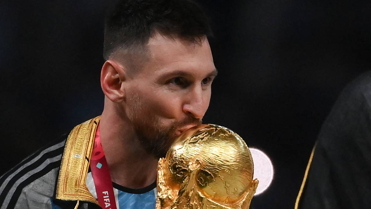 Argentina's forward #10 Lionel Messi kisses the World Cup trophy during the Qatar 2022 World Cup trophy ceremony after the football final match between Argentina and France at Lusail Stadium in Lusail, north of Doha on December 18, 2022. - Argentina won in the penalty shoot-out. (Photo by FRANCK FIFE / AFP)