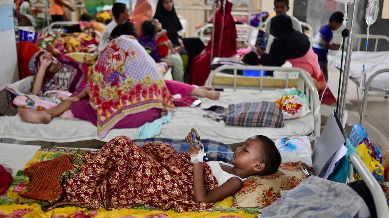 A girl suffering from dengue fever receives treatment at Mugda Medical College and Hospital in Dhaka on October 3, 2023. More than 1,000 people in Bangladesh have died of dengue fever this year, the country's worst recorded outbreak of the mosquito-borne disease, which is increasing in frequency due to climate change. (Photo by Munir uz ZAMAN / AFP)