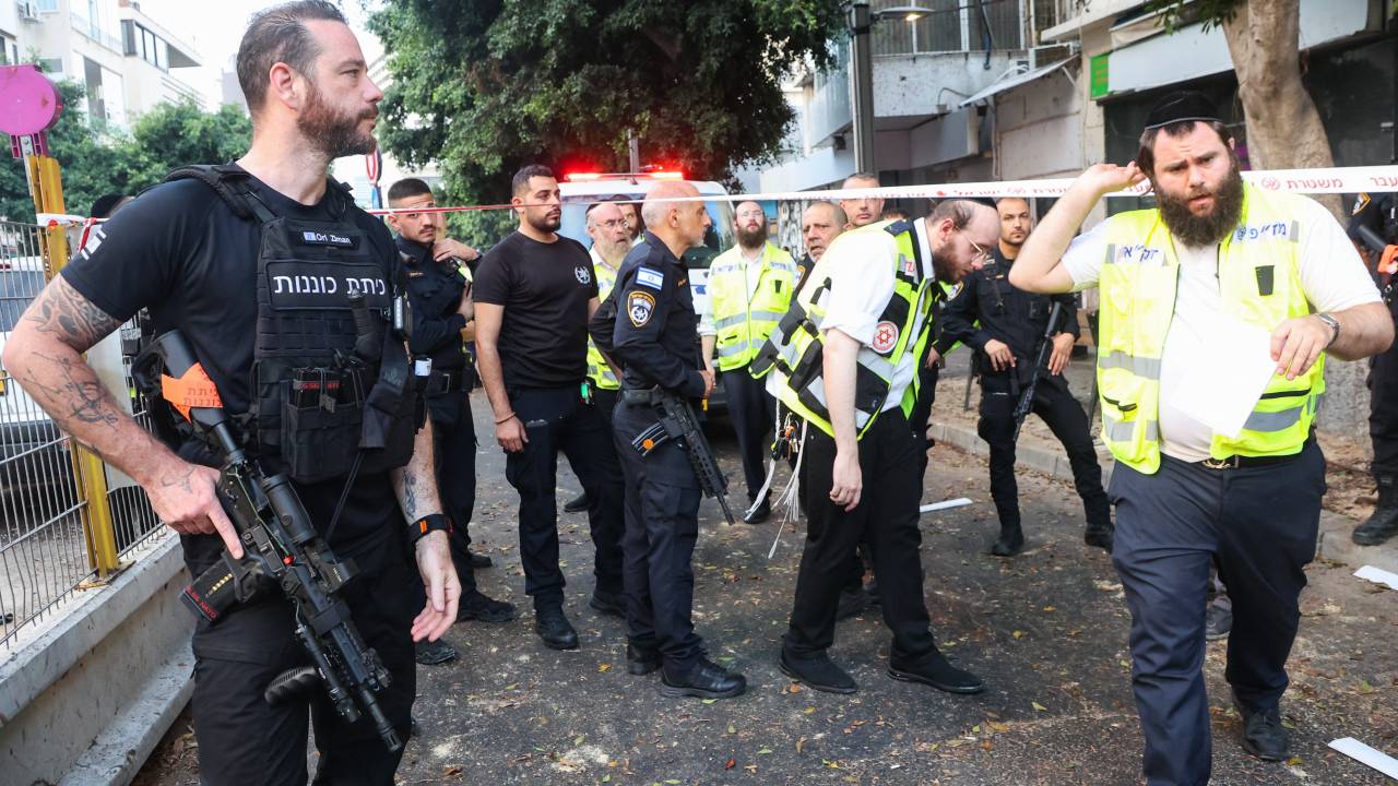 Israeli policemen search the scene where an explosion took place in Tel Aviv on July 19, 2024. Yemen's Iran-backed Huthi rebels on July 19, claimed responsibility for a drone attack on the Israeli city of Tel Aviv, where police said one person was found dead. The rebels fired a "new drone called 'Yafa', which is capable of bypassing the enemy's interception systems," Huthi military spokesman Yahya Saree said in a statement on social media. (Photo by GIL COHEN-MAGEN / AFP)