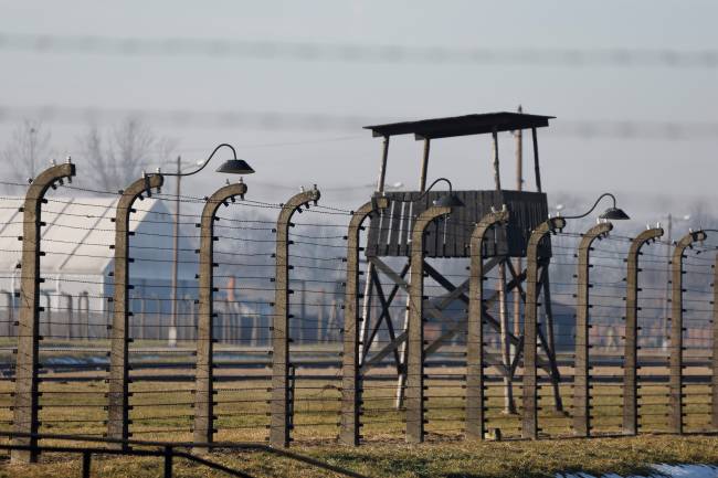 This picture taken on january 27, 2025, shows fences and parts of the former Auschwitz concentration camp, on january 27, 2025, in Oswiecim, Poland, ahead of commemorations on the 80th anniversary of the liberation of the German Nazi concentration and extermination camp Auschwitz-Birkenau by the Red Army. The camp was set up by Nazi German occupiers in southern Poland in 1940 and liberated by Soviet troops on January 27, 1945 -- just months before the end of the Second World War. (Photo by Ludovic MARIN / POOL / AFP)
