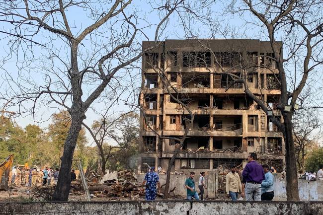 INDIA-AVIATION-CRASH A general view shows a damaged building at the site where Air India flight 171 crashed in a residential area near the airport in Ahmedabad on June 12, 2025. A London-bound passenger plane crashed in the Indian city of Ahmedabad on June 12 and all 242 people on board were believed killed, with the jet smashing into buildings housing doctors and their families. (Photo by Sam PANTHAKY / AFP)