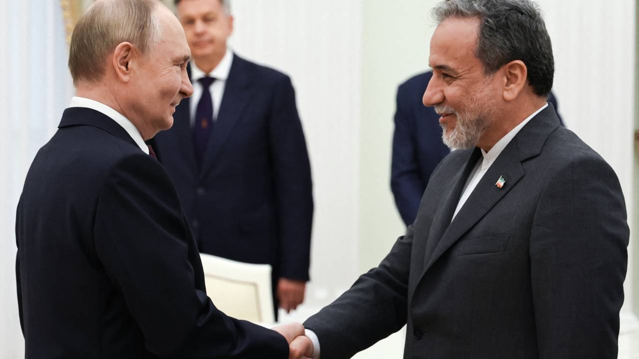 In this pool photograph distributed by the Russian state agency Sputnik, Russia's President Vladimir Putin and Iranian Foreign Minister Abbas Araghchi shake hands during a meeting at the Kremlin in Moscow on June 23, 2025. (Photo by Alexander KAZAKOV / POOL / AFP)