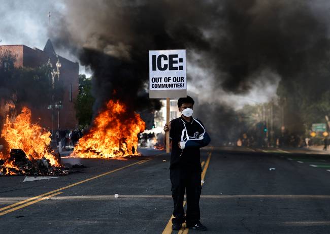 Protests Erupt In L.A. County, Sparked By Federal Immigration Raids LOS ANGELES, CALIFORNIA - JUNE 08: A protester holds a sign reading: