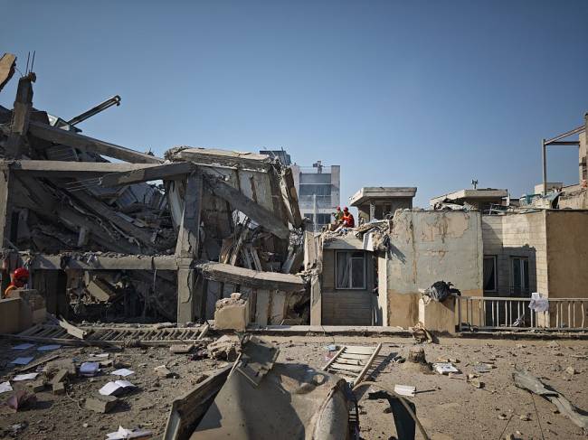 Israel Launches Strikes Against Iran TEHRAN, IRAN - JUNE 13: People look over damage to buildings following Israeli airstrikes on June 13, 2025 in Tehran, Iran. (Photo by Majid Saeedi/Getty Images)